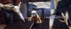 a man in a yellow jacket and white helmet is walking down the street with scissors