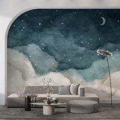 a living room with a couch, coffee table and wall mural