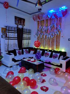 a living room decorated with balloons and streamers