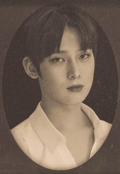 a black and white photo of a woman with short hair wearing a collared shirt