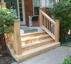 a wooden porch with steps leading up to the front door and an outside jacuzzi tub