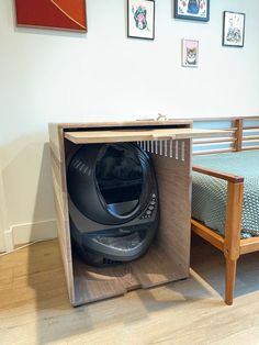 a room with a bed, chair and an open space in the middle that has a helmet on it