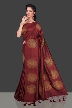 Captivating maroon borderless muga Banarasi saree for special occasions! The saree has big antique zari chakra buta. Shop online from Pure Elegance. Disclaimer: The shown stitched blouse on the model is for display purpose only. The saree comes with a matching blouse piece and finished with fall and piko. The actual product may vary slightly from the image. These are custom orders, hence expect slight variation in color, placement of the motif or buta. ESTIMATED DELIVERYBecause this is a custom Tussar Silk Saree With Self Design For Rituals, Tussar Silk Anarkali Saree For Rituals, Ceremonial Tussar Silk Saree, Traditional Brown Saree For Navratri, Gold Tussar Silk Saree For Rituals, Brown Art Silk Saree With Cutdana, Art Silk Brown Saree With Cutdana Detail, Brown Traditional Wear With Pallu For Navratri, Bollywood Style Brown Saree With Zari Weaving