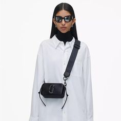 Straight From The Spring '16 Runway To The Bestseller List, Now Our Forever Icon. The Snapshot Features Tonal Design, Our Signature J Marc Hardware, A Double Zip Compartment, And A Removable And Adjustable Webbing Strap. This Classic Crossbody Bag Is Big Enough To Hold What You Need, Small Enough To Carry Anywhere. Saffiano Leather Dual Top Zip Closure Removable And Adjustable Webbing Strap Interior Slip Pocket, Exterior Slip Pocket Faille Lining Dustbag Included 7in L X 2in D X 4in H 18cm L X 6 Dkny Bryant Crossbody Bag, Black Snapshot Bag, Snapshot Bag, Classic Crossbody Bag, Adjustable Bag, Webbing Strap, Jacob Black, Marc Jacobs Bag, Black Crossbody