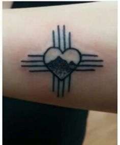 a small heart tattoo on the wrist