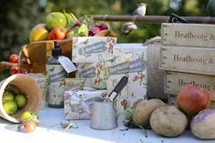 an assortment of fruits and vegetables are on a table with wooden boxes that say healthy & health