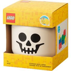 a lego skull mug in a yellow box