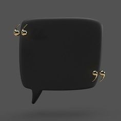 a black square object with gold studs on it's sides and an empty speech bubble in the middle