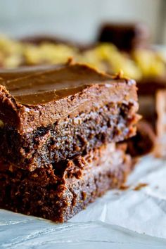 two pieces of chocolate brownie sitting on top of each other