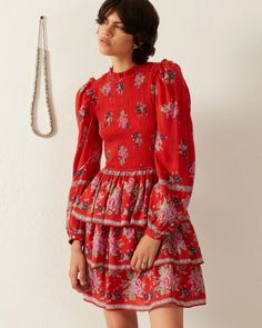 Crafted from Tencel, our red floral print dress has a smocked bodice and a short ruffled-tier skirt. The long-sleeved dress has a micro ruffle trim along the neck and armholes. The lightweight dress has a vintage-inspired silhouette. Red Long Sleeve Dress With Smocked Bodice, Red Tiered Dress With Smocked Bodice, Red Floral Print Dress, Bouquet Dress, Red Floral Print, Lightweight Dress, Spring Tops, Tier Skirt, Cotton Voile