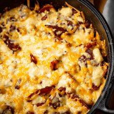 a casserole dish with cheese and bacon in it