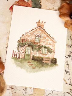 a watercolor painting of a house on paper