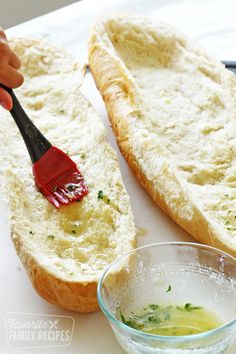 a person is brushing their bread with a toothbrush on the table next to it