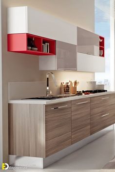 a modern kitchen with white and red cabinets