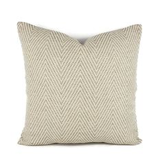 a white and beige pillow on a white background