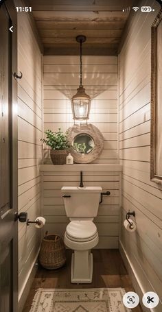 a small bathroom with a toilet, sink and rugs on the floor in front of it