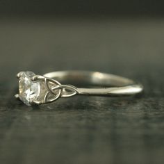 a white gold ring with a diamond in the middle