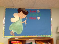 a toothbrush themed bulletin board in a child's playroom with books and toys