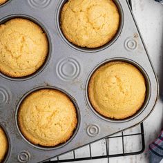 freshly baked muffins in a baking pan on a cooling rack, ready to be eaten