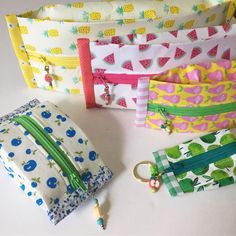 four zippered pouches lined up next to each other on a white table top