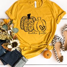 "Hello Fall Leopard Pumpkin Shirt, Leopard Print Pumpkin Fall Shirt, Ladies Fall Shirt, Halloween Pumpkin Shirt, Leopard Halloween Tee *Made to Order* All of our shirts are made to order with the sizes, colors and image specifications selected at the time your order is placed, and printed right here in the Dallas, Texas area, USA! Unless otherwise specified, our graphic tees are printed (not vinyl). We use a state of the art Direct to Garment printer which uses Eco-friendly water-based inks, sim Casual Yellow Top For Halloween, Yellow Graphic Tee For Fall, Yellow Graphic Print Shirt For Fall, Fall Yellow Crew Neck Shirt, Casual Yellow Halloween T-shirt, Yellow Crew Neck Shirt For Fall, Wedding Hoodie, Leopard Print Pumpkin, Hay Ride