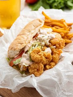 a sandwich and french fries on a wooden board