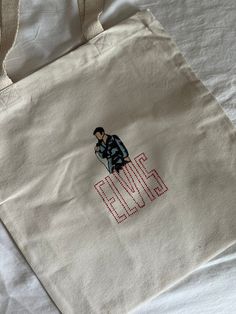 a white bag with the words elvis embroidered on it