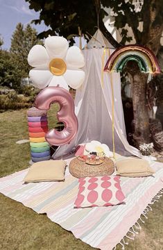 an outdoor birthday party with balloons and decorations