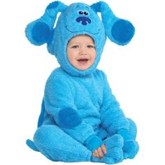 a baby in a blue dog costume sitting on the floor