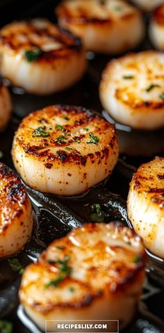 some cooked scallops sitting on top of a grill