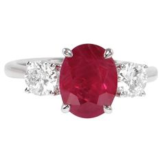 It comes with the Gemological Appraisal by GIA GG/AJP All Gemstones are Natural Ruby = 2.01 Carat 2 Diamonds = 0.60 Carats Metal: 18K White Gold Ring Size: 6.75* US *It can be resized complimentary Luxury Ruby Three Stone Rings, Luxury Oval Three-stone Ruby Ring, Oval Ruby Ring With Three Diamonds, Oval Three Stone Ruby Ring With Diamonds, Formal White Gold Ruby Ring With Three Stones, White Gold Ruby Ring, Ruby Ring Gold, White Gold Diamond Rings, Ruby Stone