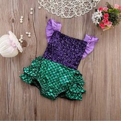 the little mermaid swimsuit is purple and green