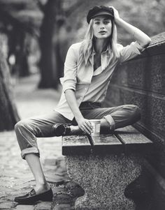 black and white photograph of a woman sitting on a bench