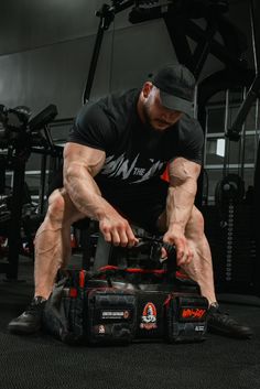 a man squatting down while working on some equipment