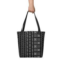 Inspired by the designs of the traditional Malian cotton fabrics, this beautiful African mud cloth tote bag design will become a trend setter among your friends. A spacious and trendy tote bag to help you carry around everything that matters. • Made to order • African Mud Cloth design is digital printed on fabric • 100% spun polyester fabric • Bag size: 15″ × 15″ (38.1 × 38.1 cm) • Capacity: 2.6 US gal (10 l) • Maximum weight limit: 44lbs (20 kg) • Dual handles made from 100% natural cotton bull Large Capacity Black Bag For Market, Black Large Capacity Shoulder Bag For Market, Traditional Black Tote Bag, Black Square Cotton Bag, Casual Rectangular Canvas Bag For Market, Black Bag With Geometric Pattern For Daily Use, Black Bags With Geometric Pattern For Daily Use, Black Bohemian Cotton Bag, Black Cotton Rectangular Beach Bag