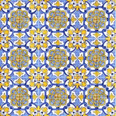 a blue and yellow tile pattern with an intricate design on the bottom half of it