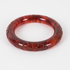 This is part of Chairish’s Costume Jewelry assortment.  Stunning red tea amber marble Bakelite bracelet bangle. Chunky rounded domed shape with a deep floral carving all around. Intense orange-red color with lots of cloudy swirling and translucency. Measurements: Inside across is 2.50 in diameter (6.4 cm) - outside across is 3.63 in diameter (9.2 cm) - width is 0.57 in wide (1.4 cm) - the wall is 0.57 in thick (1.4 cm).  Please see the measurements noted above in the description for the best app Elegant Tortoiseshell Bangle Jewelry, Luxury Red Bangle, Elegant Bakelite Bracelet Jewelry, Elegant Bakelite Bracelet, Handmade Bakelite Bangle Bracelet, Handmade Round Bakelite Jewelry, Elegant Bakelite Bangle As Gift, Elegant Bakelite Bangle As A Gift, Carved Round Bangle For Formal Events