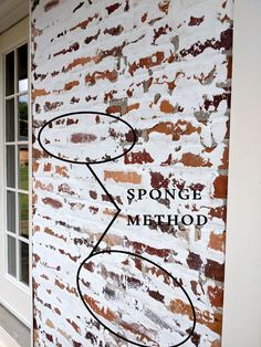 a brick wall with the words sponge method painted on it