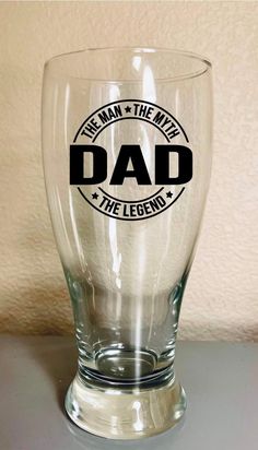 a glass with the words dad on it