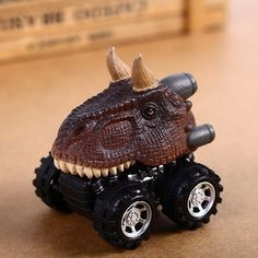 a toy car with an animal's head on the front wheel and two tires