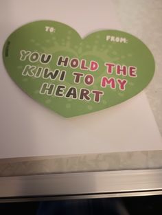 a heart shaped sticker with the words you hold the kiwi to my heart