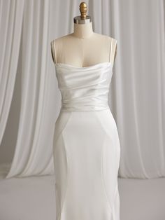 a white wedding dress on a mannequin