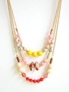 9000things | The "Fawn" necklace is a triple strand of soft pink and brown with a splash of bold red and yellow. Perfect boho chic fashion for your summer vacation ;) Fawn Necklace, Triple Necklace, Boho Chic Necklace, Gold Chain Design, Pink And Brown, Red And Yellow, Colorful Boho, Plastic Beads, Chic Fashion