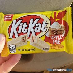 a person holding up a kitkate bar in their hand