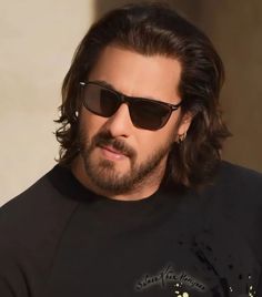 a man with long hair and sunglasses on