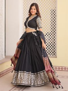 This stunning ensemble features intricate zari weaving work on the black color jacquard lehenga, choli, and dupatta, giving you a regal and elegant look. The lehenga is fully stitched up to 42 inches, and the set includes an unstitched 1-meter choli material for customization.
This ensemble includes the black color jacquard lehenga with zari weaving work, a matching jacquard choli with lace work and zari weaving, and a similar color gaji silk dupatta with printed detailing. This set is perfect f Black Chanderi Lehenga With Traditional Drape, Black Chanderi Lehenga With Zari Work, Black Brocade Dupatta For Wedding, Black Unstitched Chanderi Lehenga, Festive Black Chanderi Lehenga, Black Art Silk Lehenga For Eid, Eid Black Art Silk Lehenga, Black Art Silk Traditional Wear For Reception, Black Chanderi Lehenga