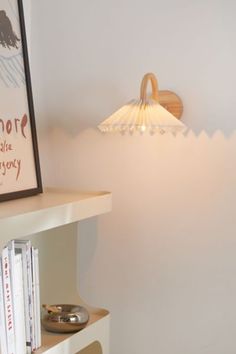 a lamp that is sitting on top of a book shelf next to a bookshelf