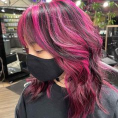 30 Wolf Cuts With Highlights | HairAide Pink Highlights In Black Hair Short, Chunky Highlights Pink And Black, Chunky Pink Highlights In Brown Hair, Wavy Wolf Cut With Bangs, Purple Chunky Highlights, Skunk Hair Wolf Cut, Pink Wolf Cut, 90s Highlights, Pink Chunky Highlights