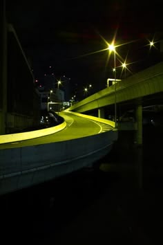 a green light is shining on the side of a bridge