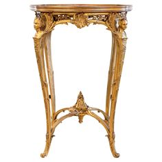 an ornately decorated table with gold paint and carvings on the top, against a white background